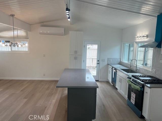 1197 Colony Dr, Pomona, CA 91766 - kitchen featuring a wall unit AC, a center island, dishwasher, a sink, and gas range oven