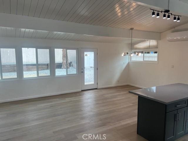 1197 Colony Dr, Pomona, CA 91766 - interior space with baseboards, plenty of natural light, a notable chandelier, and a wall unit AC