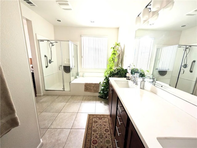 full bathroom featuring a stall shower, double vanity, a sink, and visible vents