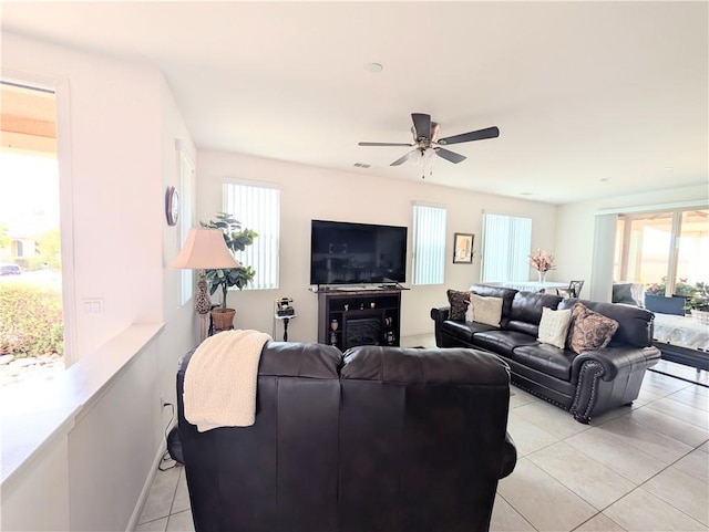 living area featuring visible vents, light tile patterned floors, and ceiling fan