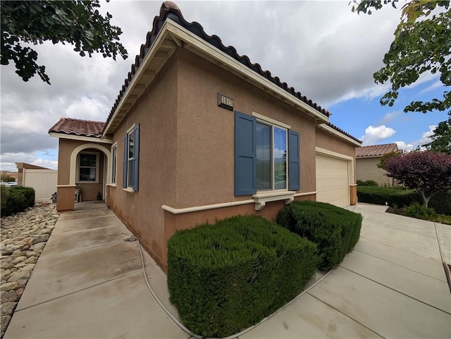 1617 Sinton Ct, Beaumont, CA 92223 - view of property exterior with stucco siding, a tile roof, and an attached garage
