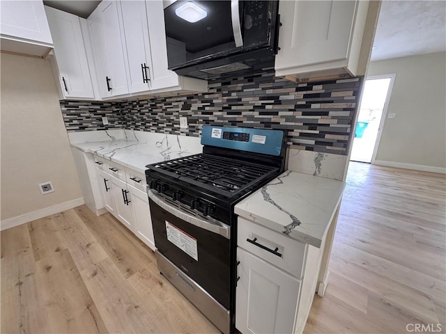 1716 Paloma St, Barstow, CA 92311 - kitchen with stainless steel gas range oven, baseboards, decorative backsplash, and light wood-style flooring