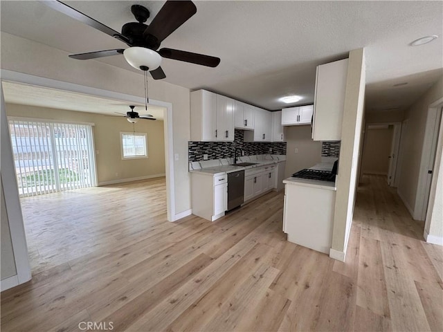 1716 Paloma St, Barstow, CA 92311 - kitchen featuring dishwashing machine, open floor plan, tasteful backsplash, a ceiling fan, and baseboards