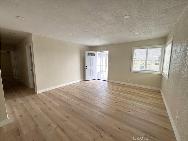 1716 Paloma St, Barstow, CA 92311 - unfurnished room with a textured ceiling, light wood finished floors, baseboards, and recessed lighting