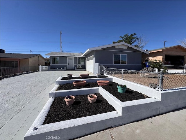 1716 Paloma St, Barstow, CA 92311 - ranch-style home featuring an attached garage, fence, and a vegetable garden