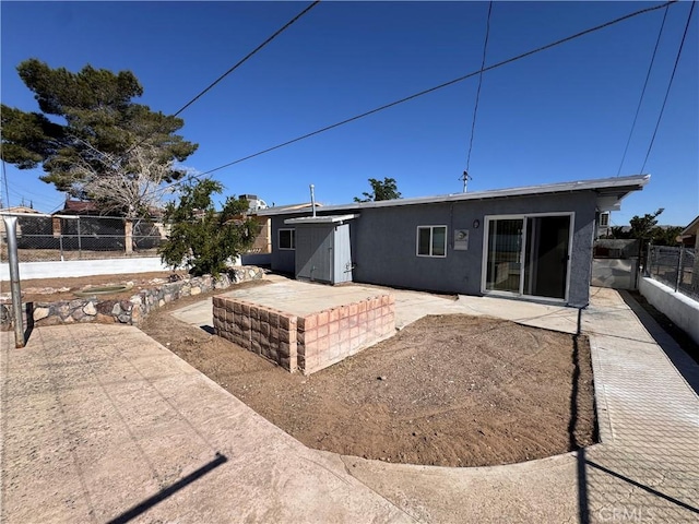 1716 Paloma St, Barstow, CA 92311 - back of property featuring a patio area, a fenced backyard, and stucco siding