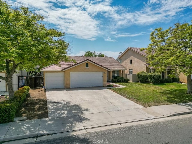 view of front of house featuring a garage, a front lawn, stucco siding, a tiled roof, and driveway