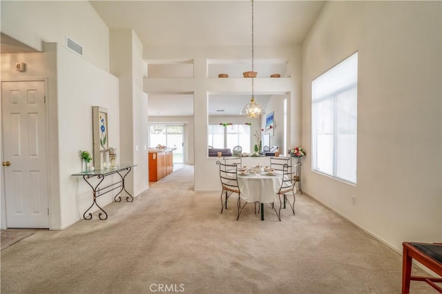 831 Kilmarnock Way, Riverside, CA 92508 - carpeted dining space featuring an inviting chandelier, a wealth of natural light, and visible vents