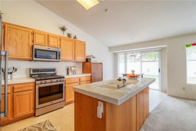 831 Kilmarnock Way, Riverside, CA 92508 - kitchen featuring pendant lighting, a sink, vaulted ceiling, tile counters, and appliances with stainless steel finishes