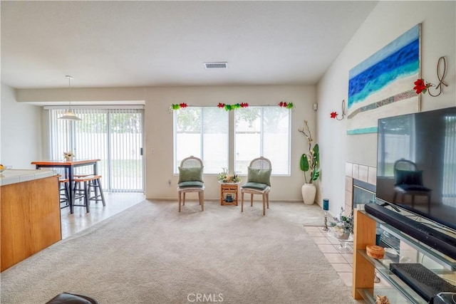 831 Kilmarnock Way, Riverside, CA 92508 - living area featuring light carpet, a tile fireplace, and visible vents