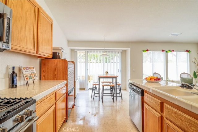 831 Kilmarnock Way, Riverside, CA 92508 - kitchen with a sink, decorative light fixtures, tile countertops, visible vents, and appliances with stainless steel finishes
