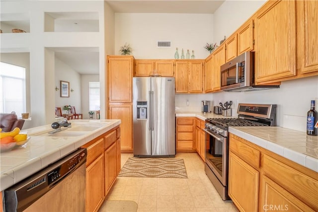 831 Kilmarnock Way, Riverside, CA 92508 - kitchen with visible vents, tile countertops, appliances with stainless steel finishes, and a sink