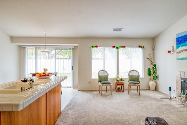 831 Kilmarnock Way, Riverside, CA 92508 - living area featuring light carpet, baseboards, visible vents, and a tile fireplace
