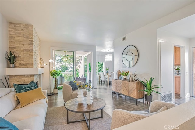 living room with visible vents and wood finished floors