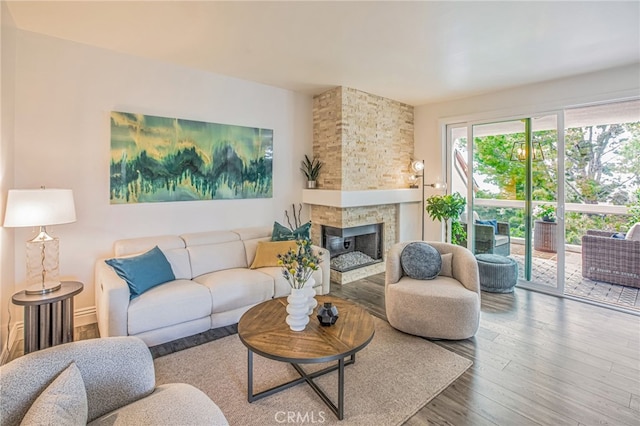 living area with a fireplace and wood finished floors