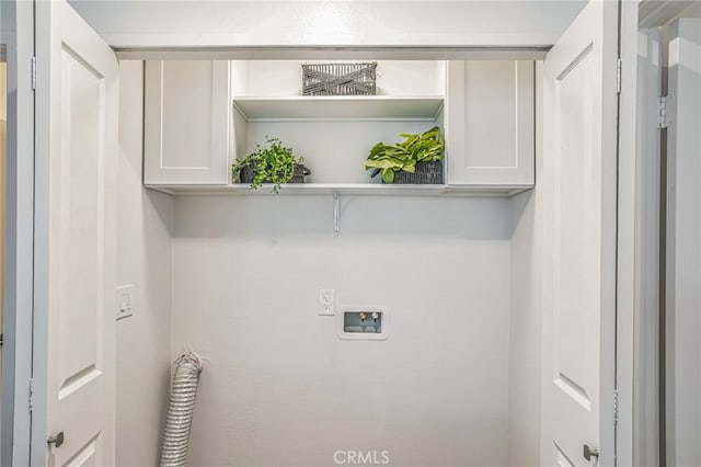 laundry area with washer hookup and cabinet space
