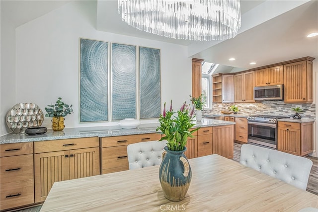 kitchen featuring light stone counters, open shelves, appliances with stainless steel finishes, and tasteful backsplash