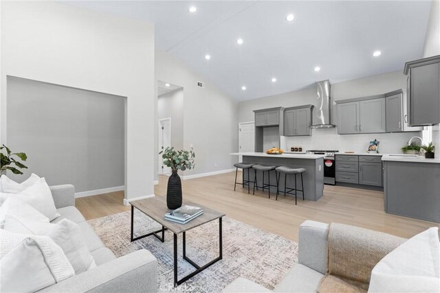 17841 Buena Vista Ave, Yorba Linda, CA 92886 - living room with high vaulted ceiling, light wood-style flooring, and recessed lighting