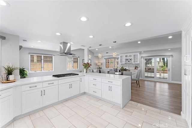 17841 Buena Vista Ave, Yorba Linda, CA 92886 - kitchen with island range hood, open floor plan, recessed lighting, light countertops, and white cabinets