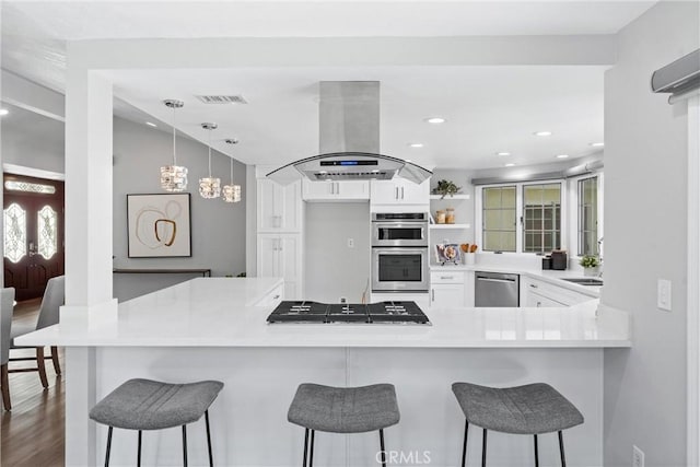 17841 Buena Vista Ave, Yorba Linda, CA 92886 - kitchen featuring island exhaust hood, appliances with stainless steel finishes, white cabinetry, open shelves, and a peninsula