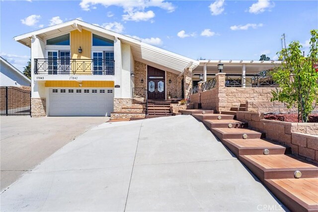 17841 Buena Vista Ave, Yorba Linda, CA 92886 - view of front of house with a garage, stone siding, a balcony, and driveway