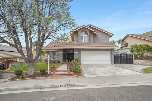 22425 Poplar St, Saugus, CA 91390 - traditional-style home with a gate, driveway, a tiled roof, a garage, and stucco siding