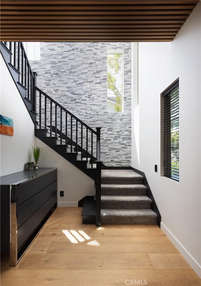 stairs featuring baseboards and wood finished floors