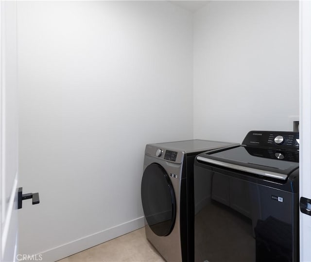 laundry area featuring washer and clothes dryer, baseboards, and laundry area