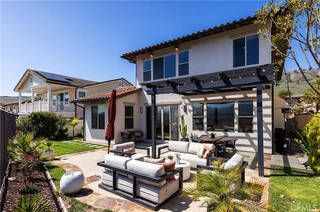 rear view of property with outdoor lounge area, fence, a pergola, stucco siding, and a patio