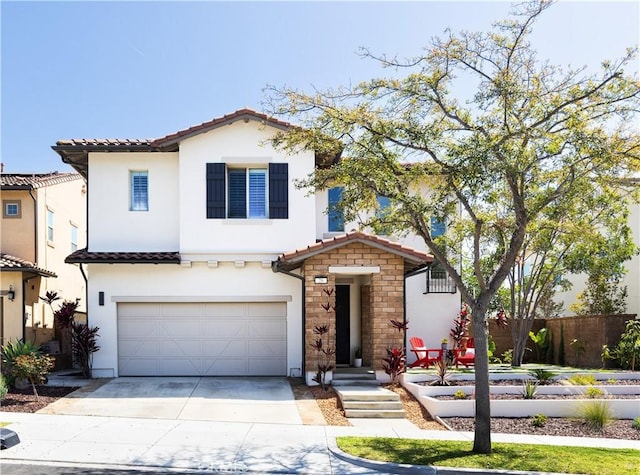 mediterranean / spanish house featuring concrete driveway, fence, a tiled roof, and a garage