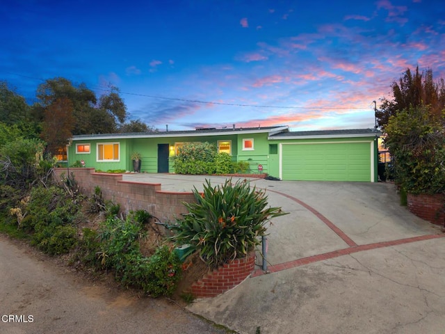 675 Mount Wilson Trl, Sierra Madre, CA 91024 - ranch-style house with concrete driveway, an attached garage, and roof mounted solar panels