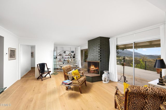 675 Mount Wilson Trl, Sierra Madre, CA 91024 - living room featuring wood finished floors, crown molding, a brick fireplace, and a mountain view
