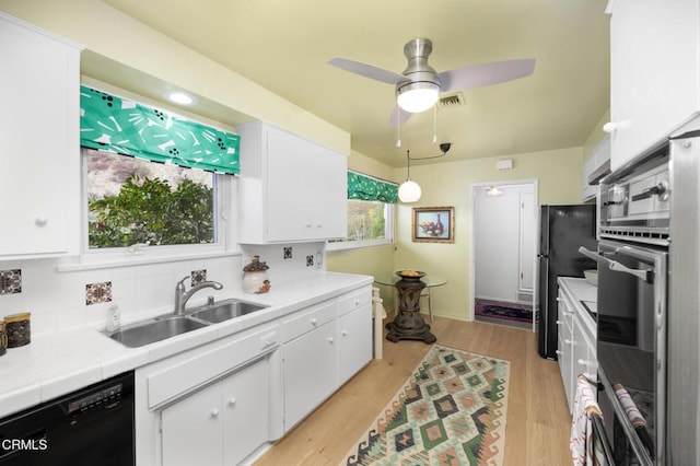 675 Mount Wilson Trl, Sierra Madre, CA 91024 - kitchen with dishwasher, a sink, white cabinets, freestanding refrigerator, and tasteful backsplash