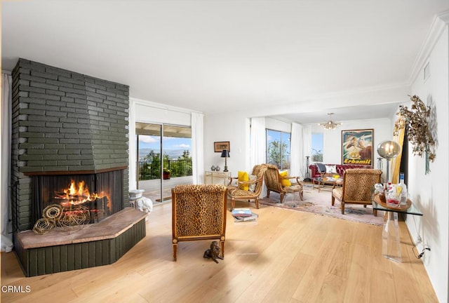 675 Mount Wilson Trl, Sierra Madre, CA 91024 - living area featuring wood finished floors, a brick fireplace, and a chandelier