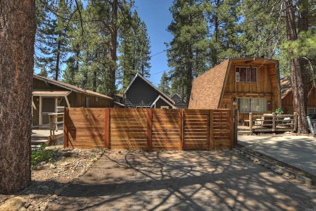 331 W Sherwood Blvd, Big Bear City, CA 92314 - exterior space featuring fence and a gambrel roof