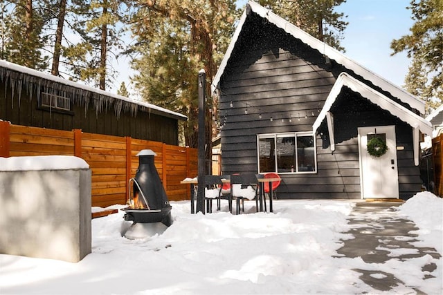 331 W Sherwood Blvd, Big Bear City, CA 92314 - snow covered back of property with an outdoor fire pit and fence