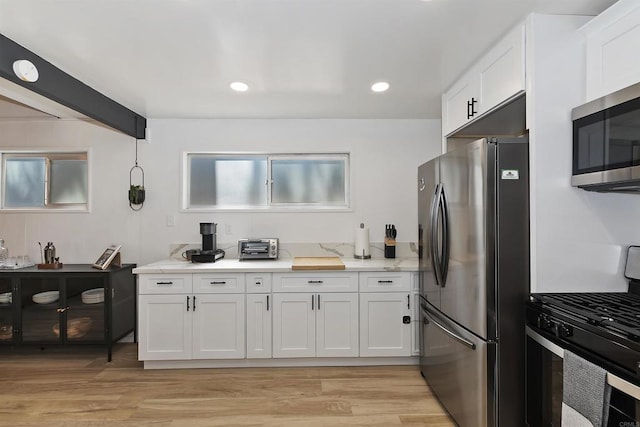 331 W Sherwood Blvd, Big Bear City, CA 92314 - kitchen featuring a wealth of natural light, white cabinets, light wood-style floors, and stainless steel appliances
