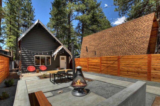 331 W Sherwood Blvd, Big Bear City, CA 92314 - view of patio / terrace featuring a fenced backyard, an outdoor fire pit, and outdoor dining space