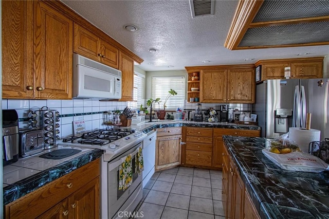 7469 Madera Ave, Hesperia, CA 92345 - kitchen featuring open shelves, a sink, brown cabinets, decorative backsplash, and white appliances