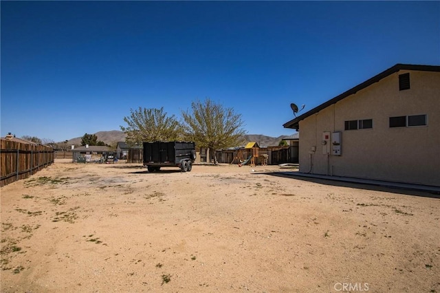 7469 Madera Ave, Hesperia, CA 92345 - view of yard with a playground, fence, and a mountain view