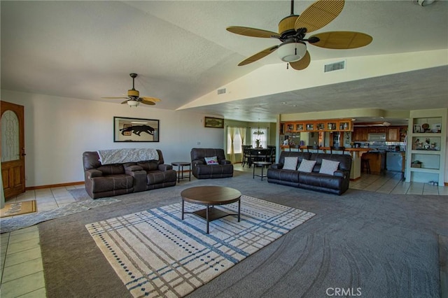 7469 Madera Ave, Hesperia, CA 92345 - tiled living room featuring a textured ceiling, vaulted ceiling, visible vents, and a ceiling fan