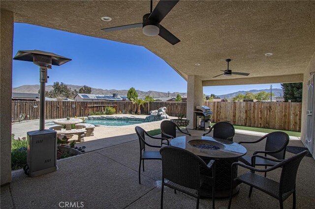 7469 Madera Ave, Hesperia, CA 92345 - view of patio / terrace with a fenced backyard, a mountain view, a fenced in pool, and ceiling fan