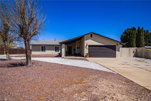 7469 Madera Ave, Hesperia, CA 92345 - single story home featuring concrete driveway, an attached garage, fence, and stucco siding