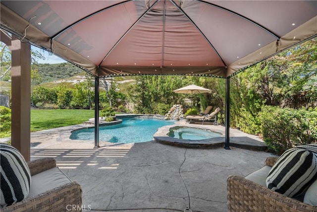 view of pool with a patio area, a gazebo, a pool with connected hot tub, and a lawn