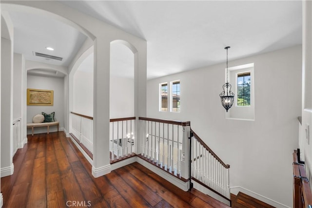 hallway with an upstairs landing, hardwood / wood-style floors, baseboards, and recessed lighting
