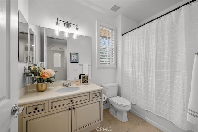 bathroom featuring tile patterned floors, toilet, vanity, and shower / bath combo