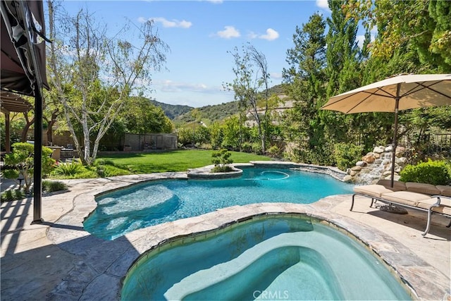 outdoor pool with an in-ground hot tub, a mountain view, and a patio