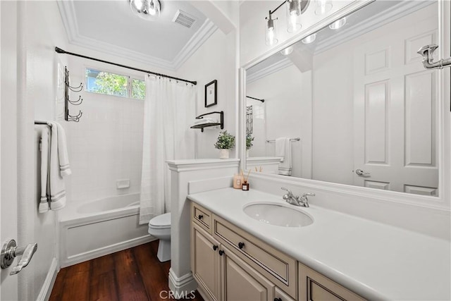 full bathroom with wood finished floors, toilet, vanity, crown molding, and shower / bath combo