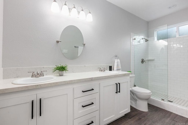full bath featuring toilet, a sink, and a shower stall