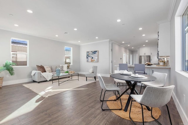 dining room featuring ornamental molding, recessed lighting, wood finished floors, and baseboards